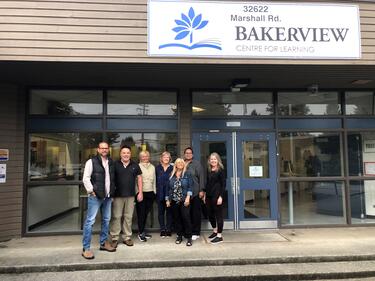 Bakerview Staff standing in front of the entrance to the school